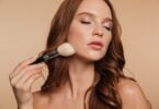 Beauty portrait sensual ginger woman with long hair closed eyes applying cosmetics with brush 171337 940