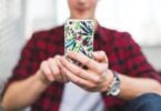 Young man texting on iphone