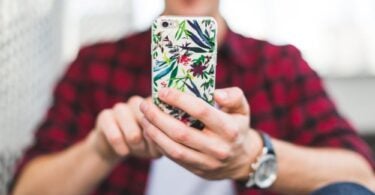 Young man texting on iphone